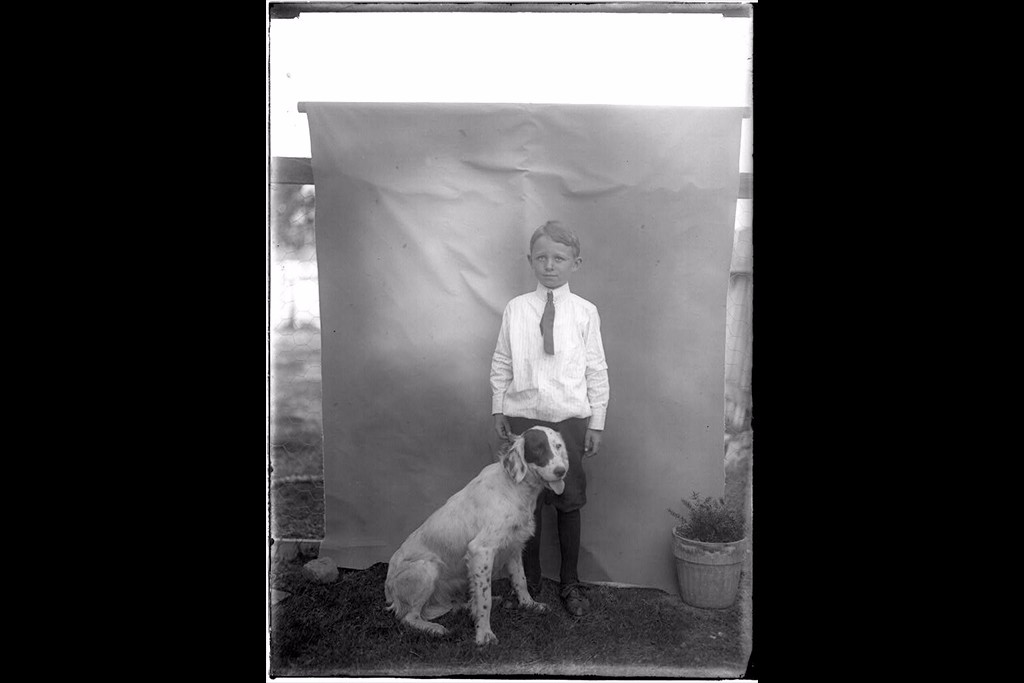 Child (boy) with dog.