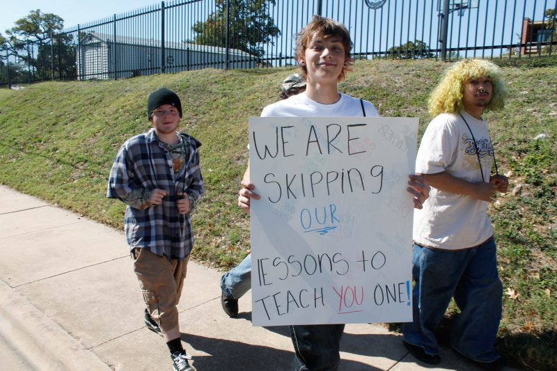 young protesters carry a sign on the way to the Capitol